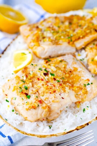 Baked lemon garlic tilapia filets served over rice.