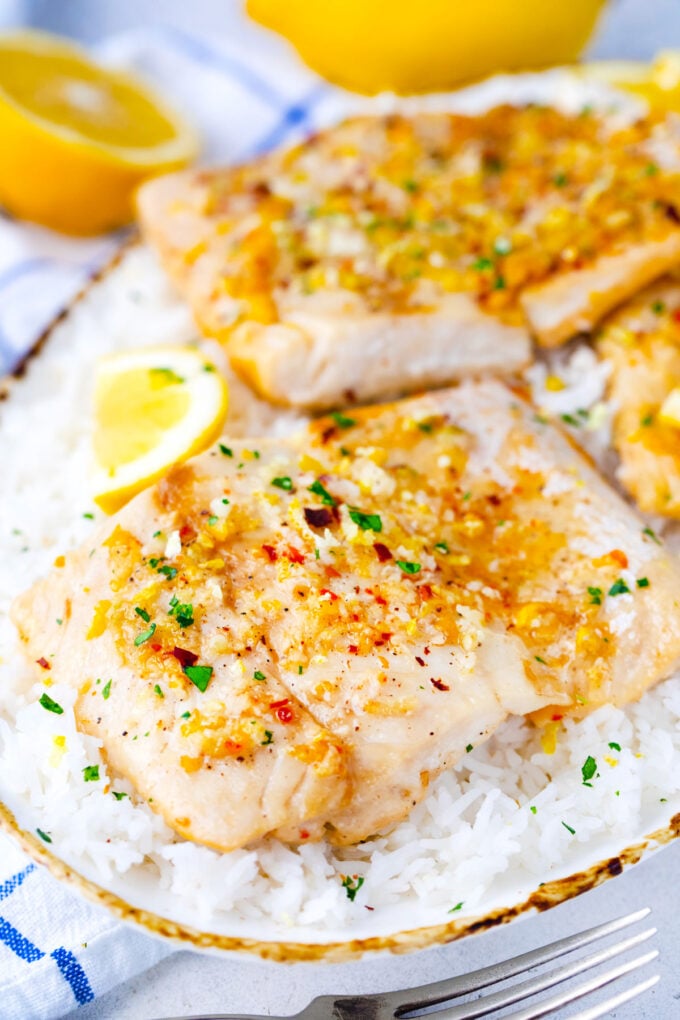 Baked lemon garlic tilapia filets served over rice.