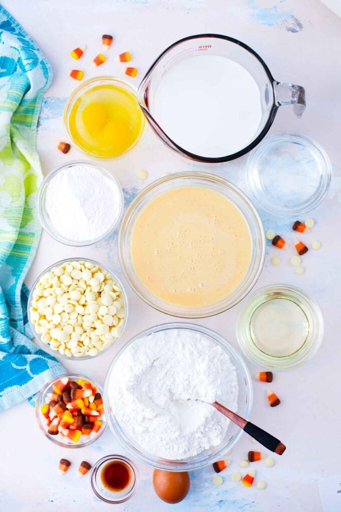 candy corn poke cake ingredients in bowls on a table