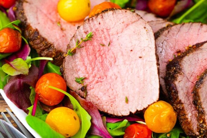 sliced, juicy, and with a pink center red wine roasted beef tenderloin