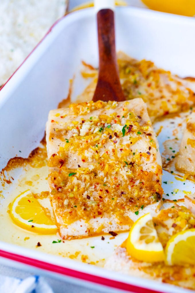 Baked lemon garlic tilapia on a serving spatula.