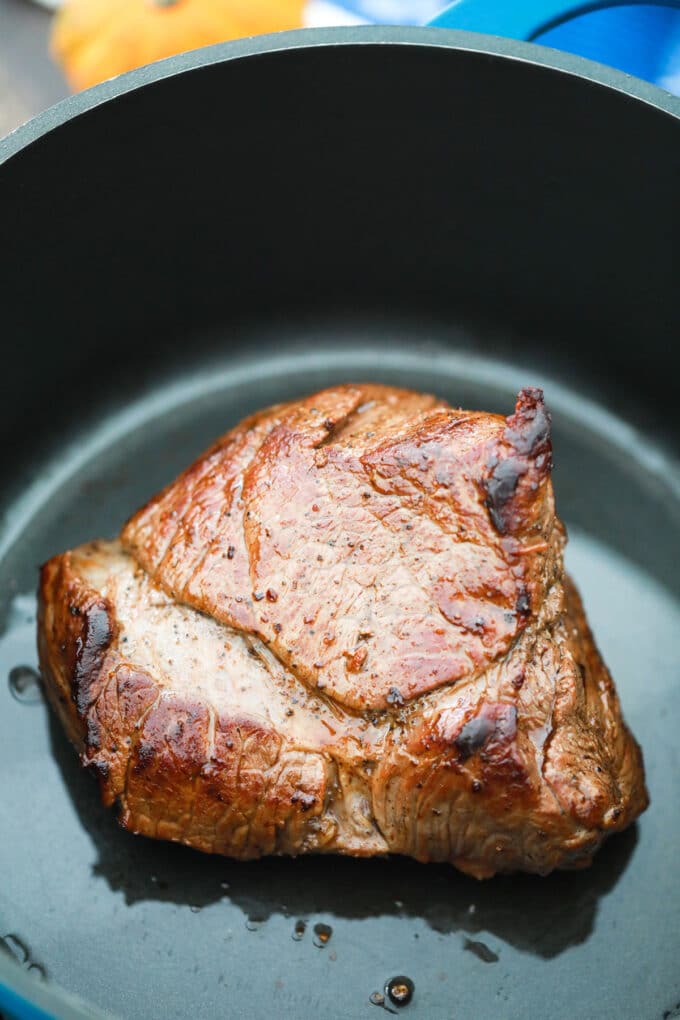 Searing meat in a Dutch oven.