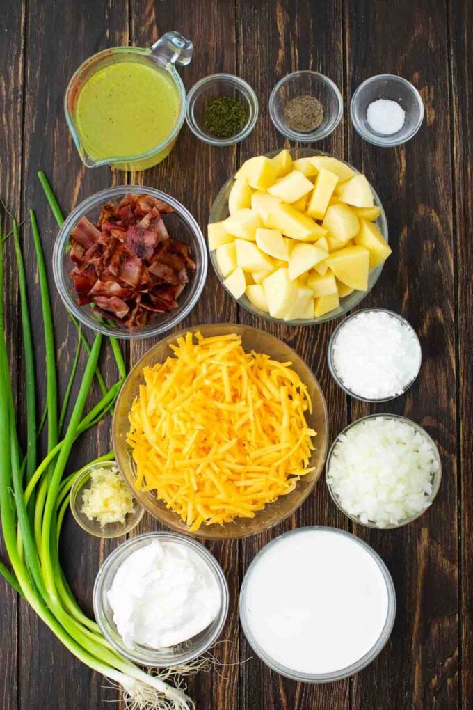 slow cooker baked potato soup ingredients in bowls on a wooden table