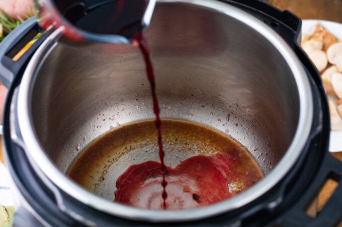 Deglazing the Instant Pot with wine.