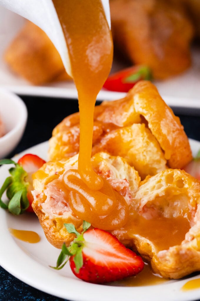 Drizzling a homemade popover with caramel sauce.