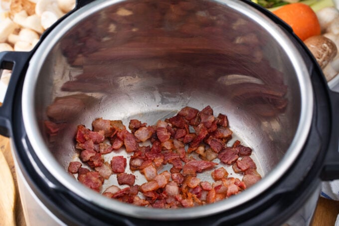 Searing bacon pieces in the Instant Pot.