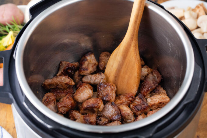Searing lamb pieces in the Instant Pot.