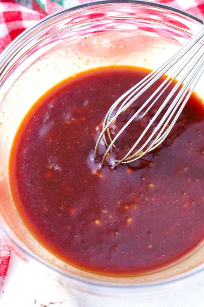 whisking korean fried chicken sauce in a bowl