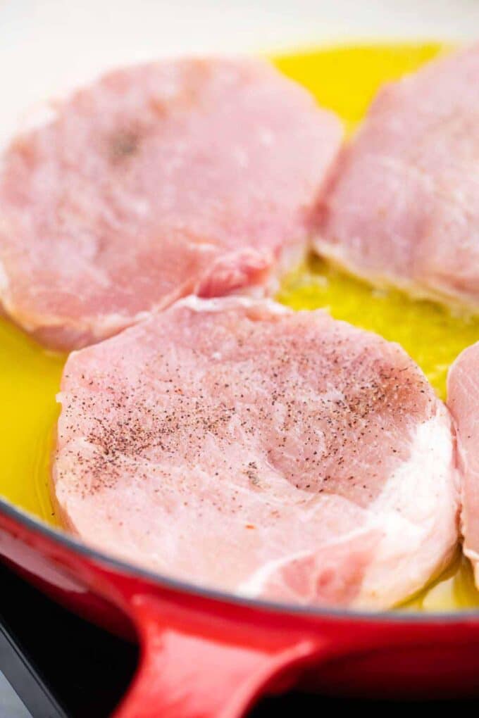 searing boneless pork chops in a skillet