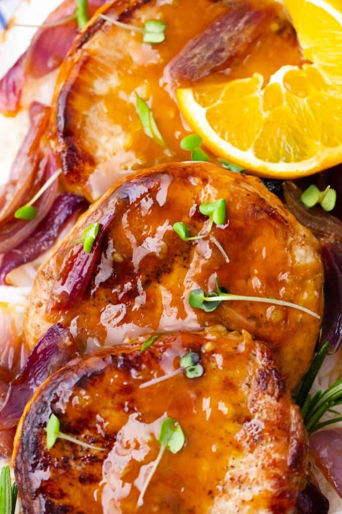 juicy and perfectly browned boneless pork chops covered in orange sauce glaze