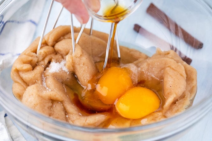 Whisking eggs into churro dough.