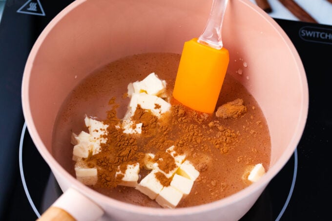 Stirring butter. cinnamon, and brown sugar in a bowl.