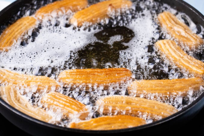 Frying homemade churros.