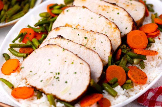 Homemade brown sugar roasted pork loin with green beans and carrots.