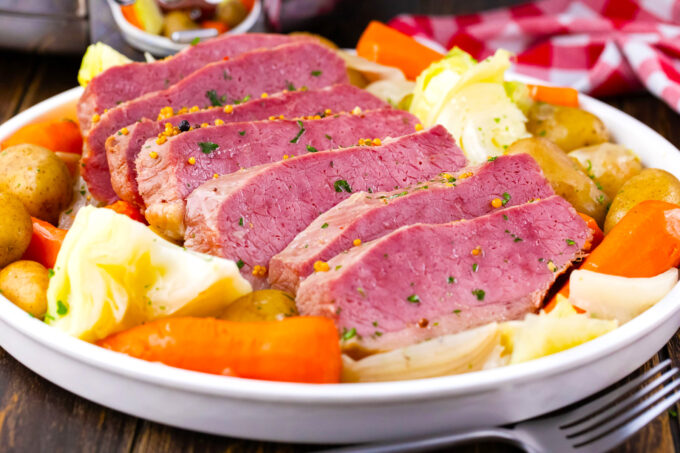 Tender slow cooker corned beef with carrot, cabbage, and potatoes.