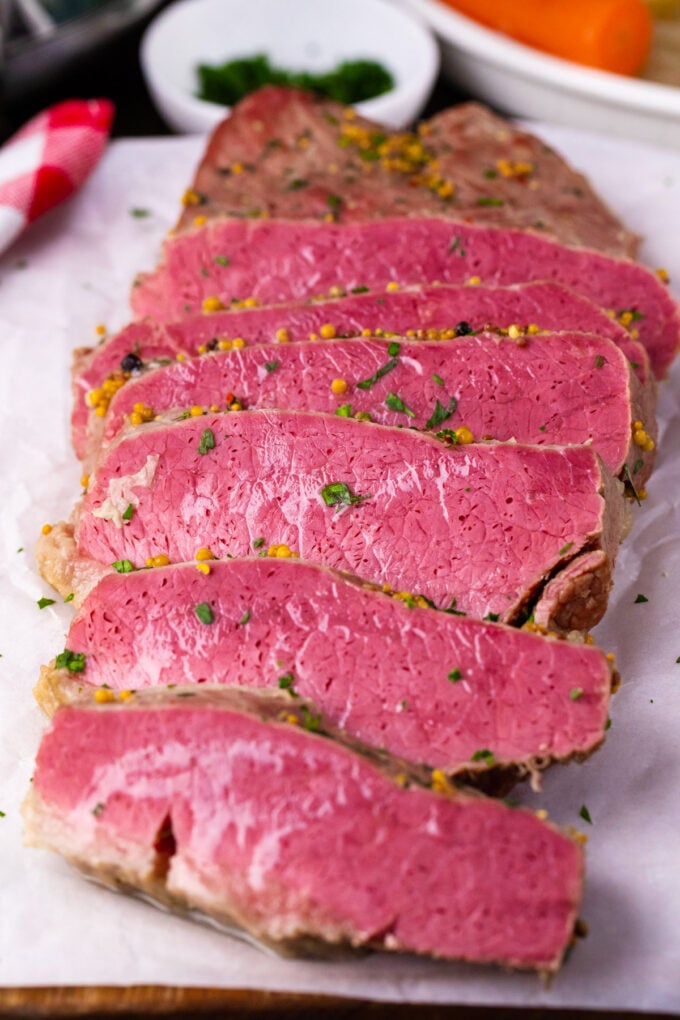 Sliced slow cooker corned beef on a plate.