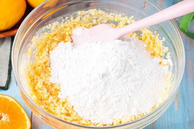 Stirring dry ingredients into wet ingredients.