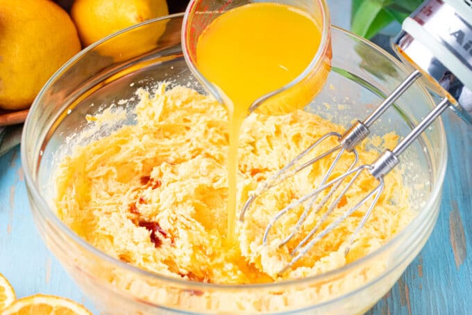 Adding orange juice into whisked butter.