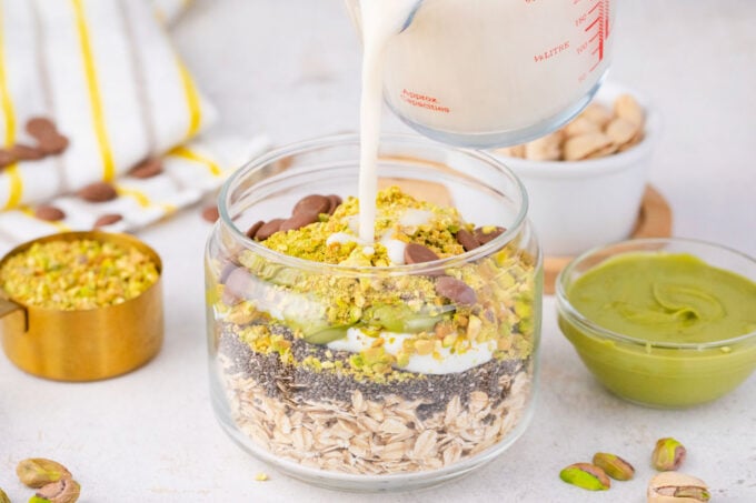 Dubai chocolate overnight oats ingredients in a jar.
