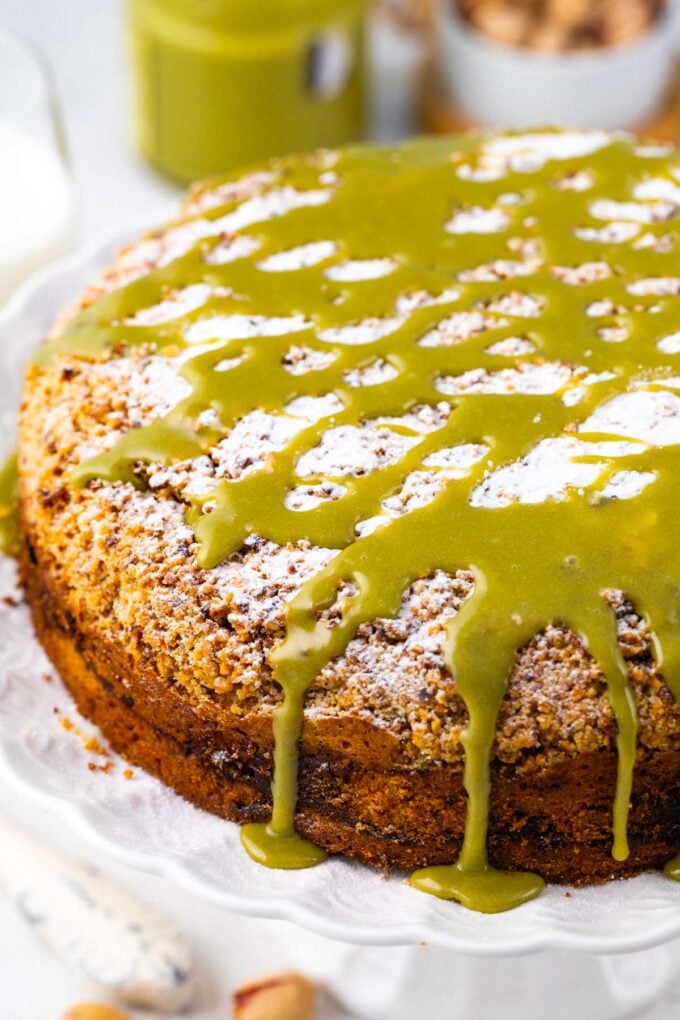 Pistachio coffee cake topped with powdered sugar and pistachio cream.