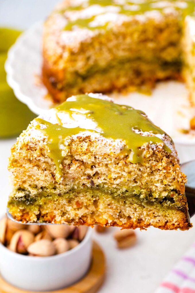 A slice of pistachio coffee cake on a serving spatula.