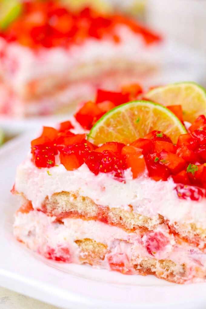 A slice of creamy strawberry margarita tiramisu topped with freshly diced strawberries.
