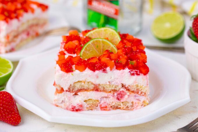 A slice of creamy strawberry margarita tiramisu topped with diced strawberries.