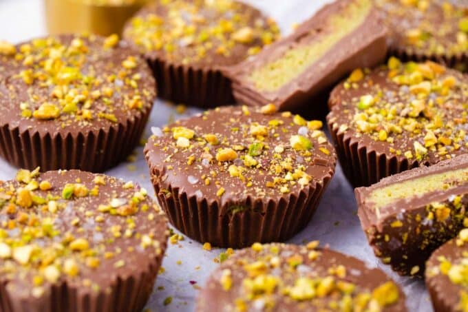 Dubai chocolate pistachio cups on a serving board.