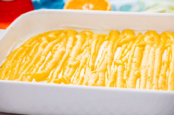 Assembling Aperol spritz tiramisu.