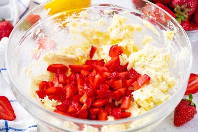 Adding fresh strawberries to whipped butter.