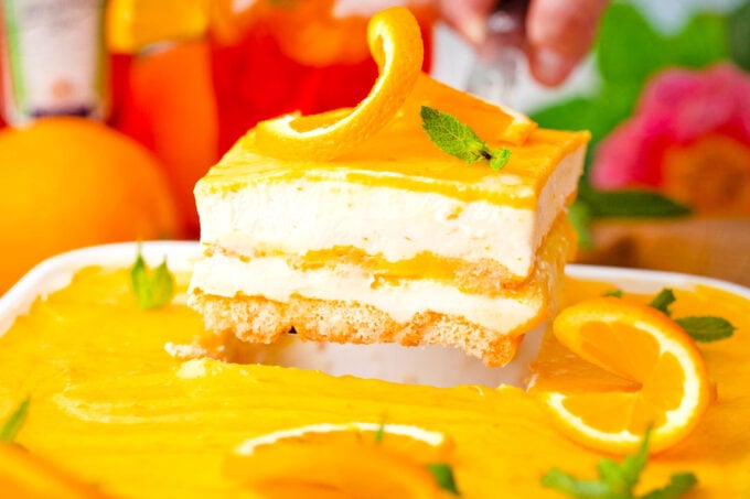 A slice of Aperol spritz tiramisu on a serving spatula.
