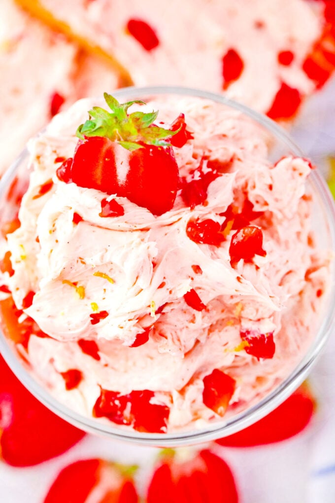 Overhead shot of a bowl of whipped strawberry butter with fresh strawberries.