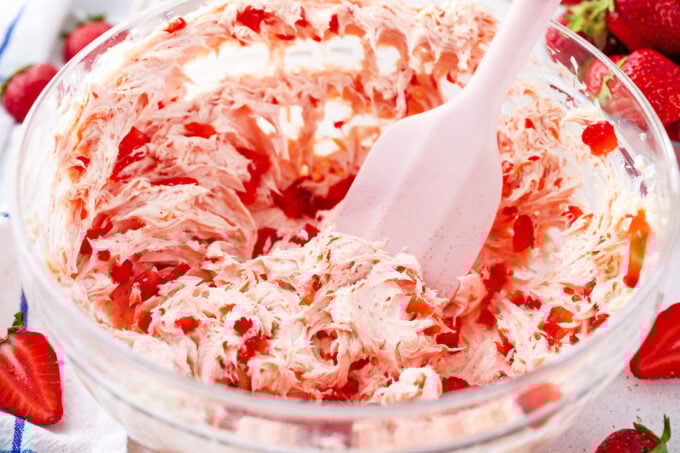 strring fresh strawberry butter in a bowl.