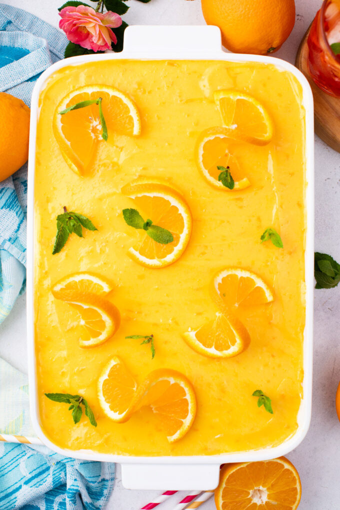 Aperol spritz tiramisu topped with orange curd and orange slices.