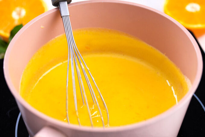 Orange curd in a sauce pan.