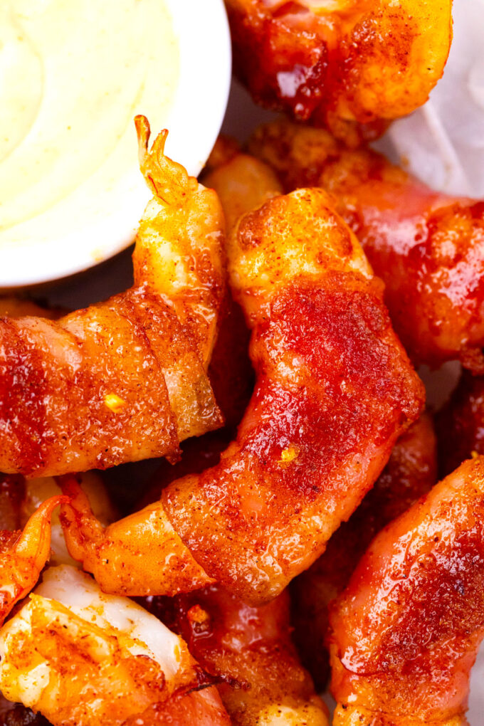 Crispy bacon wrapped shrimp with brown sugar served with a creamy sauce.