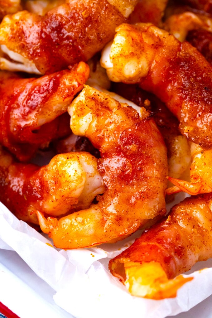 Close shot of bacon wrapped shrimp with brown sugar on a tray.