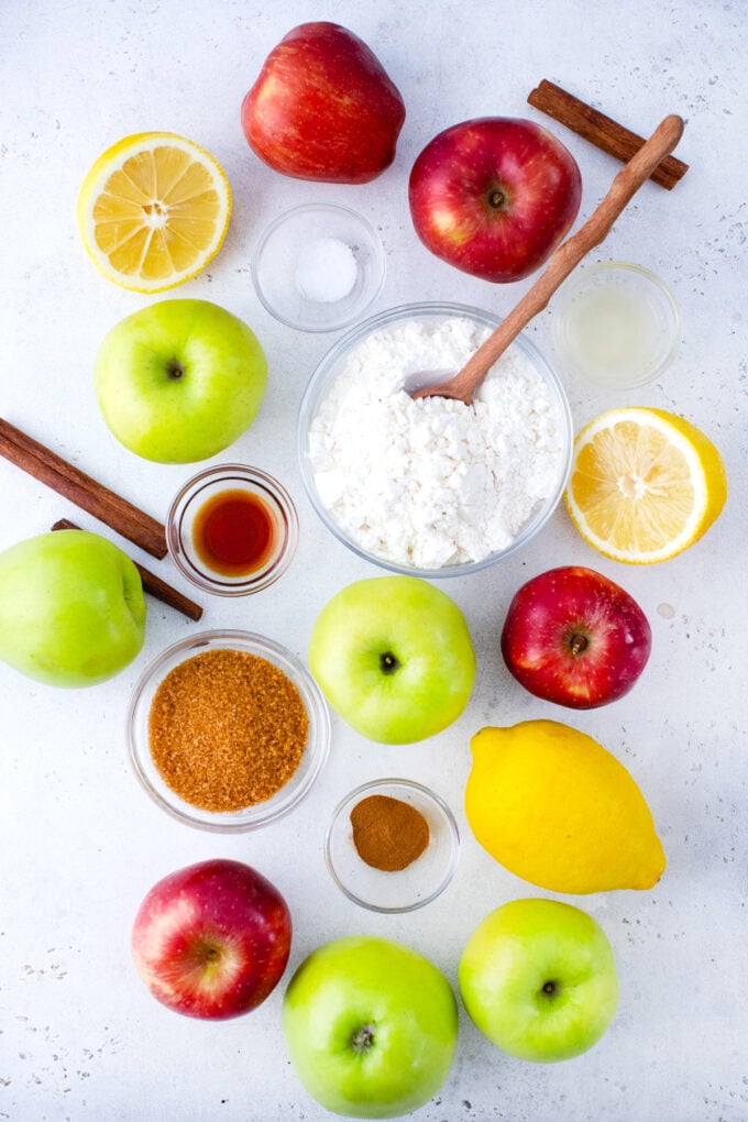 Overhead shot of apple tart ingredients arranged on a white surface.