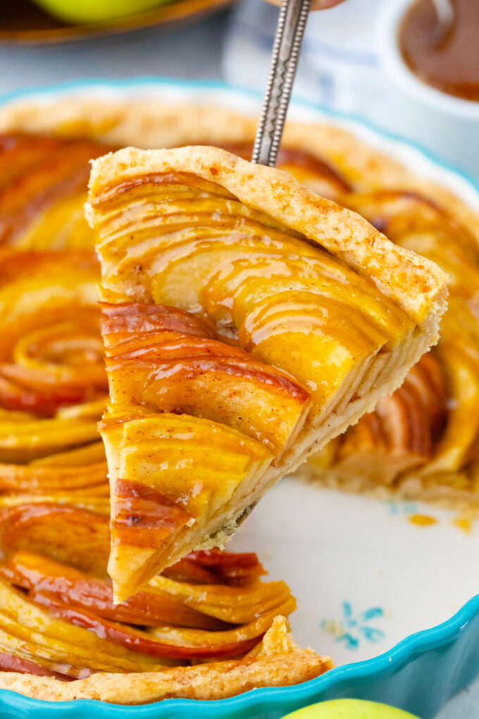Homemade apple tart slice on a serving spatula.