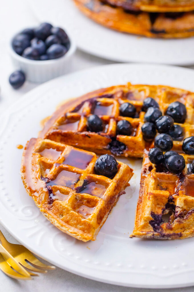 Gluten free cottage cheese banana waffles with maple syrup and blueberries.