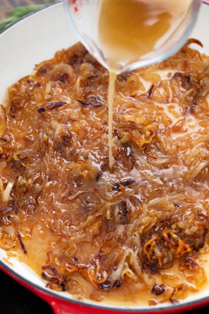 Adding beef stock to caramelized onions.