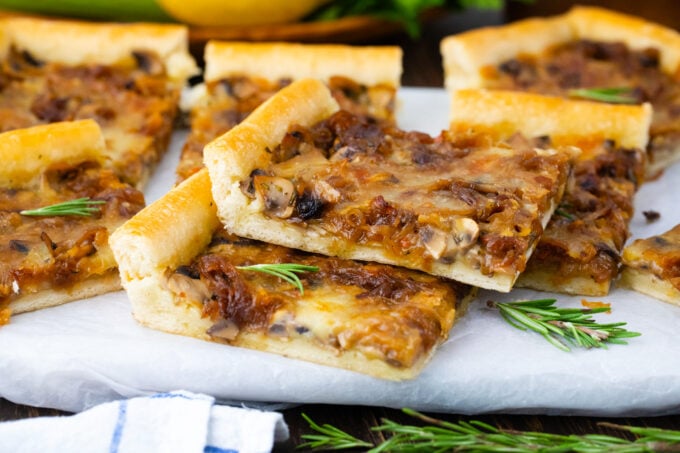 Sliced puff pastry caramelized onion tart with mushrooms.