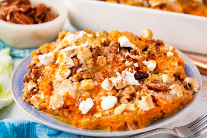 Homemade sweet potato casserole with marshmallows and pecans.