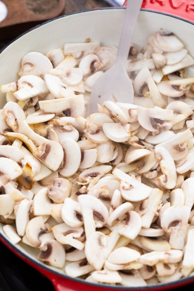 Sauteing mushrooms in a slillet.