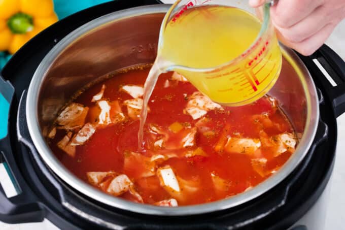 Adding broth to Instant Pot Cabbage Soup.