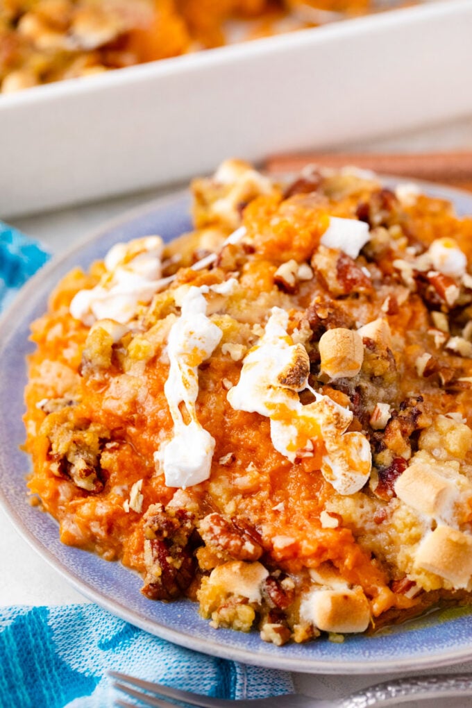 Creamy sweet potato casserole with melted marshmallows and pecans.