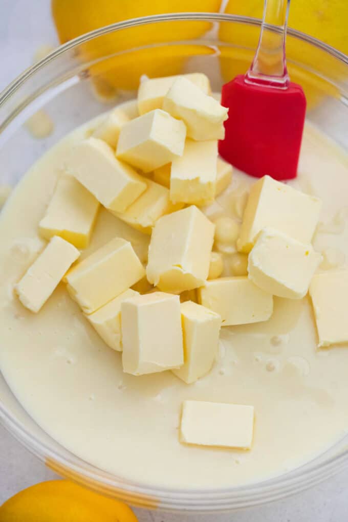 Butter in a bowl of melted white chocolate.