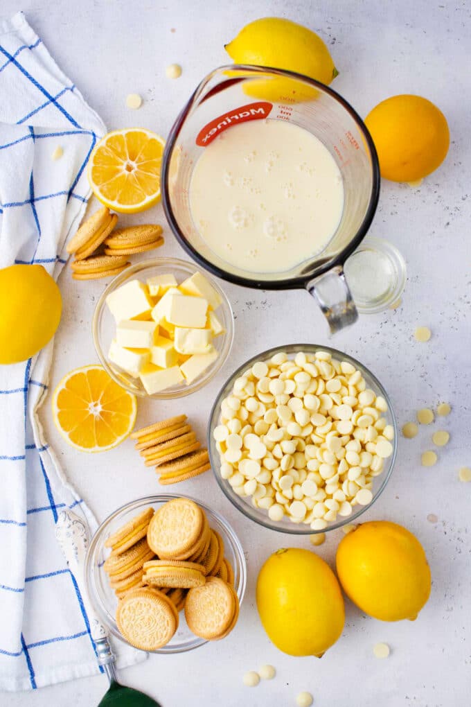 Overhead shot of lemon Oreo fudge ingredients arranged on a white surface.