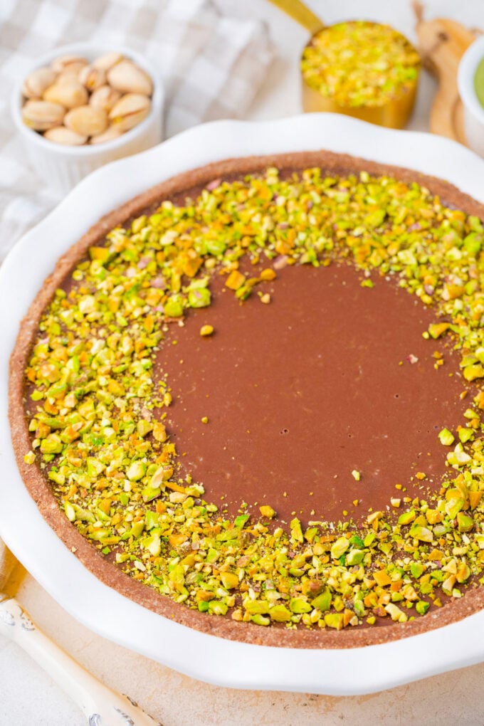 Overhead shot of homemade Dubai chocolate tart topped with chopped pistachios.