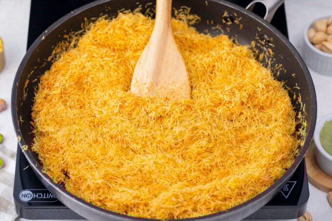 Frying kataif in a pan.